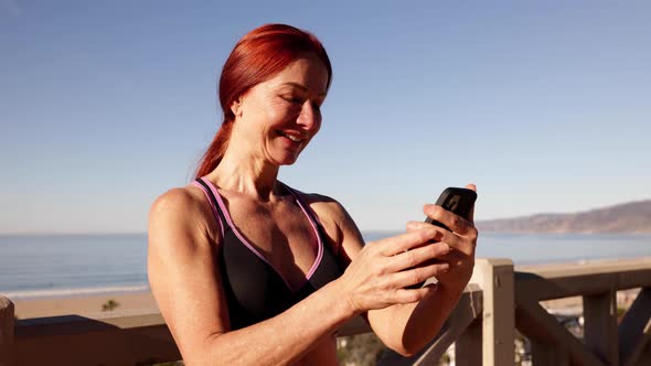 Mature Woman Exercising At The  Beach