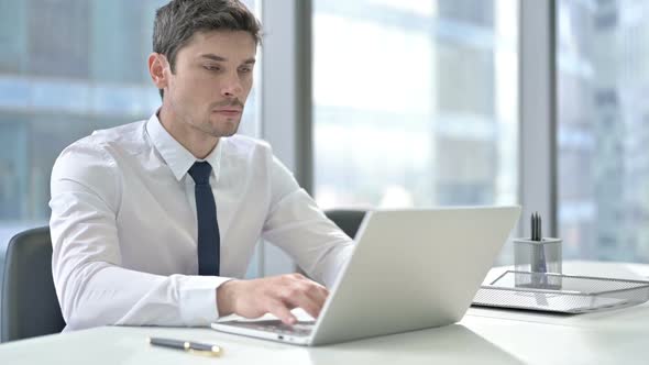 Young Businessman Working on Laptop