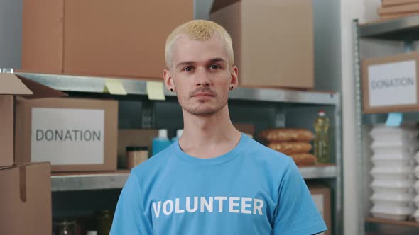 Portrait of Man in Volunteer Tshirt Posing at Food Bank