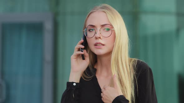 Worried Nervous Caucasian European Blonde Woman Holding Mobile Phone Angrily Talking to Bank Service