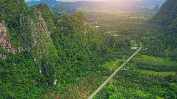 An aerial view from a drone flying over a beautiful mountain view road