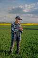Modern Farmer Researcher Using Digital Tablet at Agricultural Field - PhotoDune Item for Sale