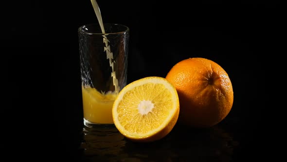 Fresh Orange Juice Being Poured Into a Glass