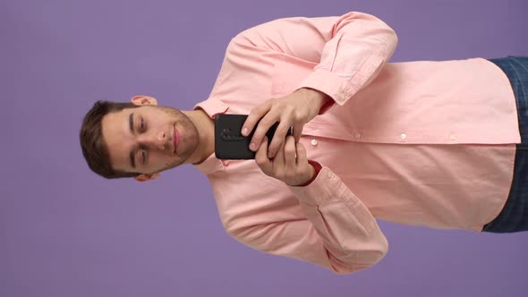 Vertical Studio Portrait of Happy Young Man Using Smartphone Say Wow Yes Just Found Out Big Win News