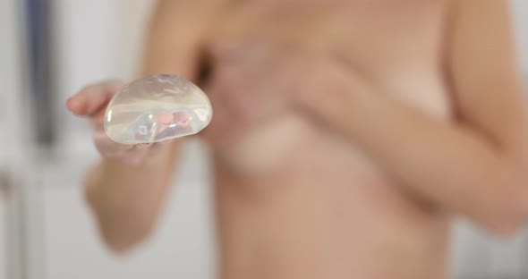 Woman is Holding Silicone Breast Implant Slow Motion  Movie