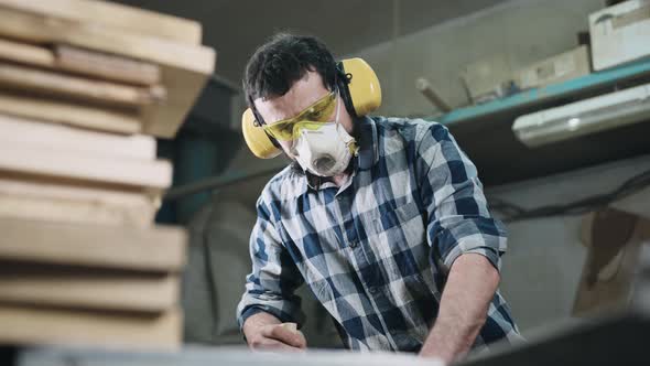 A Man Works with a Planer