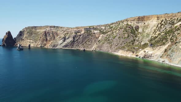 Aerial View From Above on Calm Azure Sea and Volcanic Rocky Shores