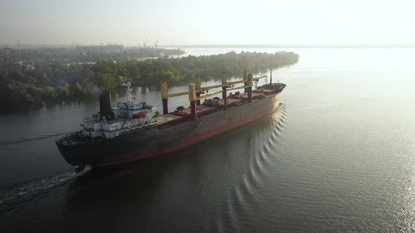 Slowmo Aerial Cargo Bulker with Bulk Commodities Sailing From Seaport After Loading Coarse Grain on