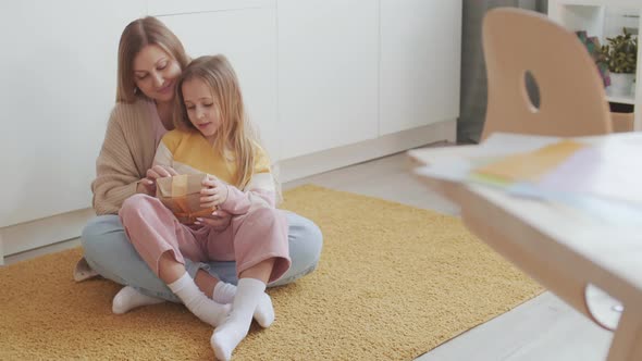 Woman Receiving Gift from Her Child