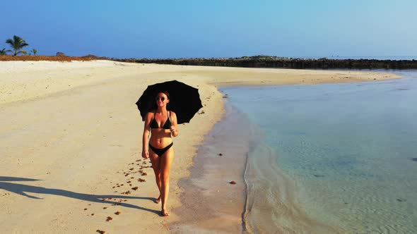 Tourists posing on tropical shore beach voyage by turquoise sea with bright sandy background of Thai