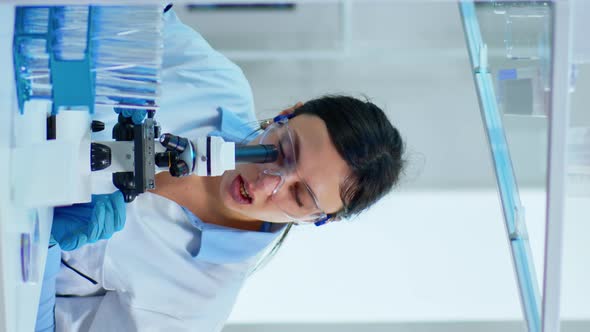 Vertical Video Team Medical Scientist Conducting DNA Experiments Under Digital Microscope