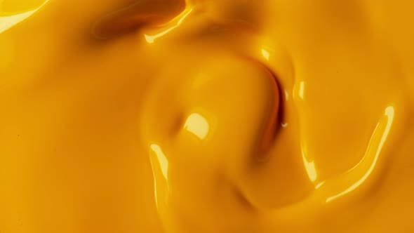 Super Slow Motion Shot of Swirling Yellow Fluid Background at 1000Fps