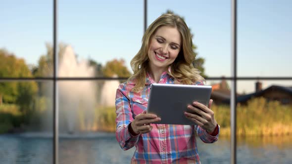 Young Happy Woman Using Portable Digital Tablet.