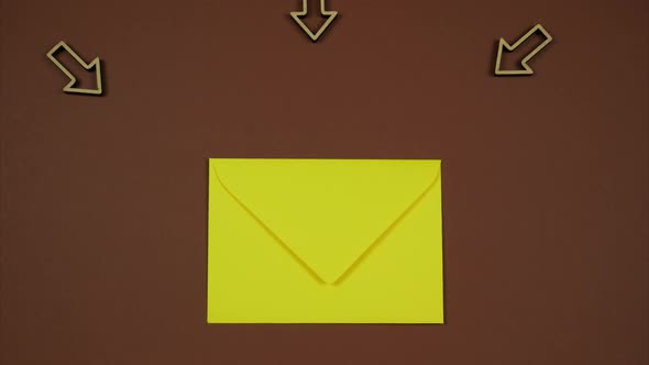 Yellow Envelope With Incoming Arrows Over Brown Background