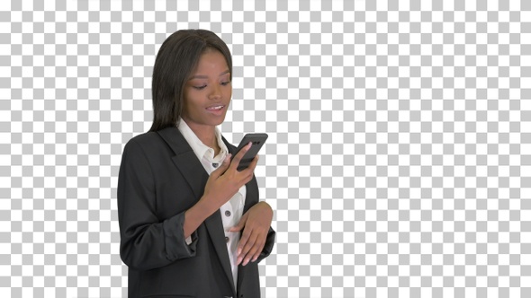 Smiling black woman texting on her cell phone, Alpha Channel