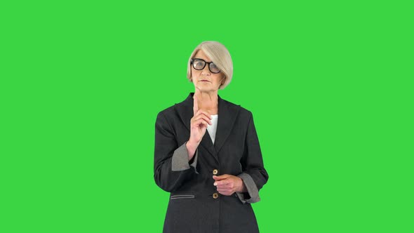 Attention Warning and Old People Concept Portrait of Serious Senior Woman Pointing Finger Up on a