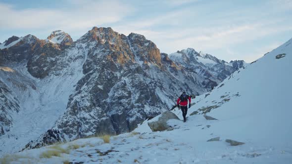 Man Running at the Mountain with Snow