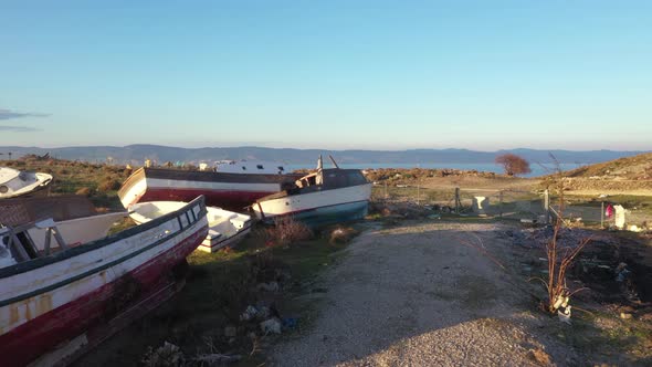 Abandoned boats on Lesvos coast of Turkey in distance AERIAL