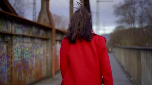 Happy Lady Is Strolling on Street in Sunny Fall Day, Camera Is Following Her