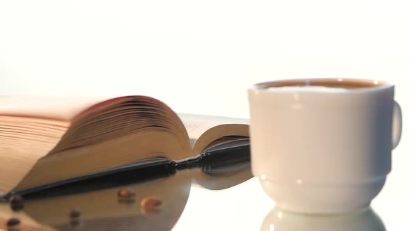 Cup of Delicious Coffee, Milk with Turning Pages Book Isolated on White Background