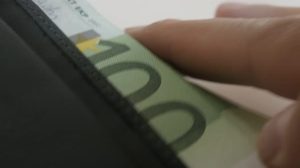 Taking of black leather wallet close-up  3840X2160 UltraHD footage - Hand takes  bi-fold money case 