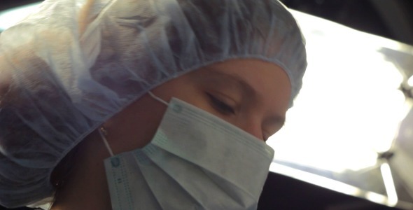 Young Female Doctor Preparing For Surgery