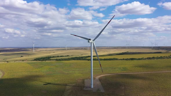 Aerial View Over the Farm Landscape and Wind Turbines Generating Clean Renewable Energy