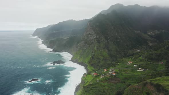 Aerial Footage of Charming Coastal Houses at the Edge of a Cliff