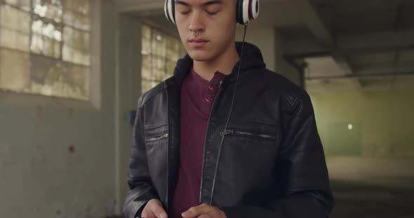 Fashionable young man in an abandoned warehouse