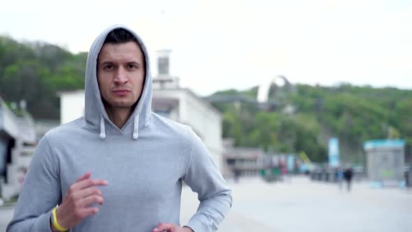 Young modern man starts running exercise in the morning. Fit man jogging outdoor