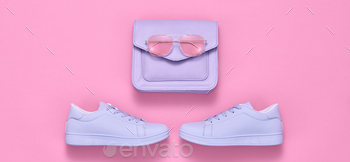  sneakers, handbag clutch. Pop art purple concept. Woman fashionable accessories on pink, top view, banner. Creative design color