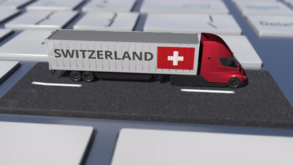 Truck with Flag of Switzerland Moves on the Keyboard