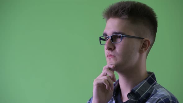 Closeup Profile View of Happy Young Hipster Man Thinking