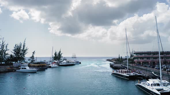 Aerial view of the bay with yacht and dancing people on a boat in Bridgetown, Barbados