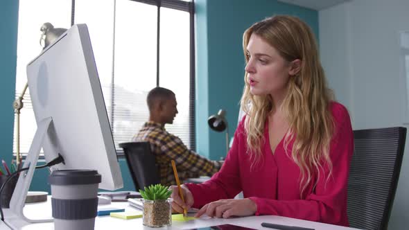 Man and woman working on computers