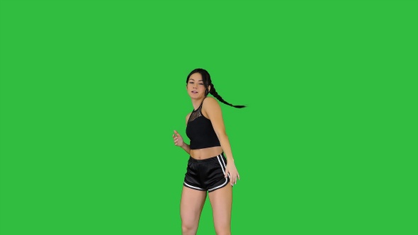 R'n'B girl in shorts walking dancing on a Green Screen, Chroma Key.