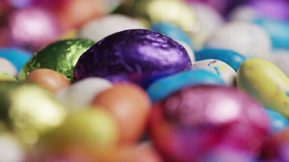 Rotating shot of colorful Easter candies on a bed of easter grass