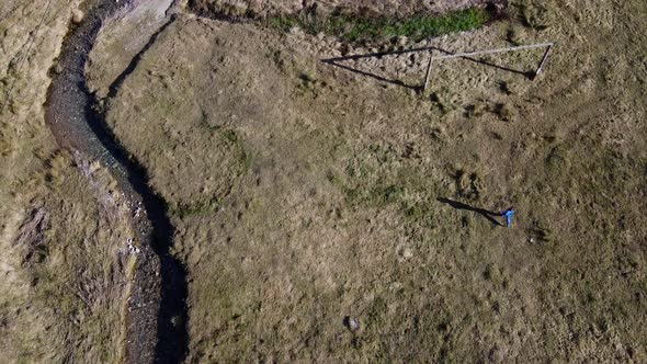 Drone view of kid walking near river