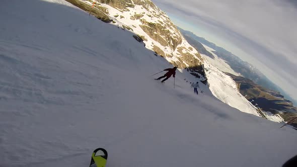 Young man skiing down a snow covered mountain.