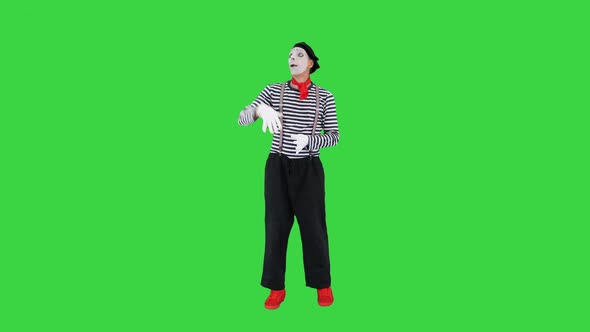 Mime Artist Holding Imaginary Balloons and Flying on a Green Screen Chroma Key