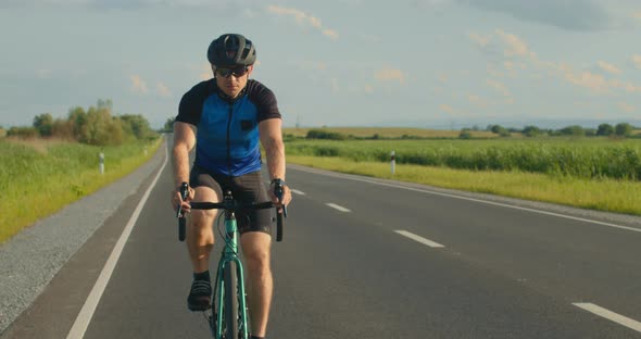 Sportsman is Riding a Bicycle on the Track