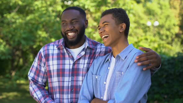 Young Black Man Hugging Younger Brother Laughing Having Fun Together, Family