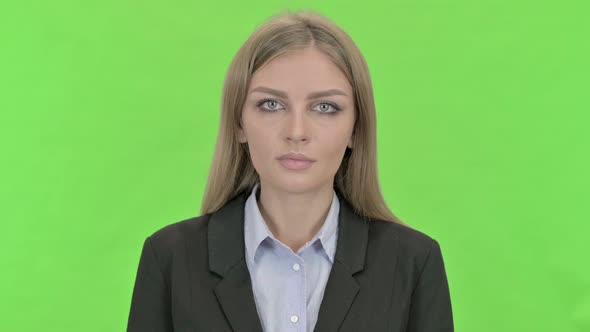 Young Businesswoman Looking at Camera Against Chroma Key