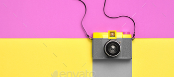 flat lay. Retro design camera on vivid color. Summertime concept. Trendy fashionable film camera, creative pop art