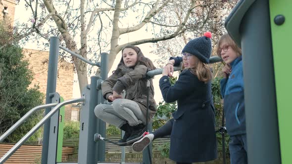 Children playing telephone game on the schoolyard during break time