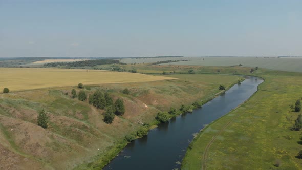 Top View of The River, Surrounded by Trees and Meadows on Its Banks, View from The Top - Aerial