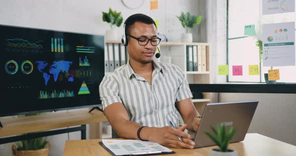 Businessman Wearing Headphones with Mic, Taking Part in Online Web Camera Negotiations Meeting