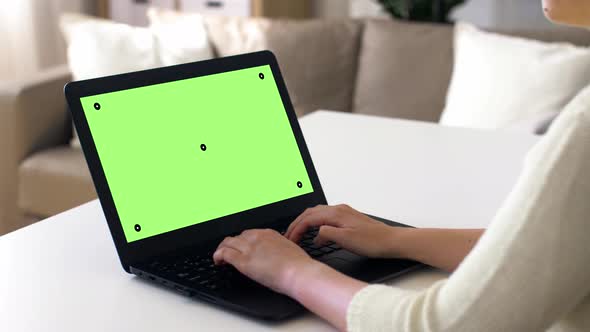 Woman with Chroma Key Green Screen on Laptop