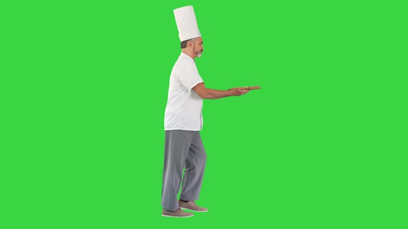 Cook Walking in a Hurry with a Pizza in His Hands on a Green Screen, Chroma Key