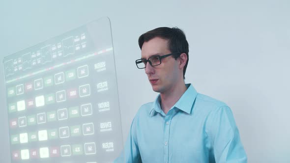 Financial Analyst Working on a Computer with Futuristic Transparent Monitor with Realtime Stocks